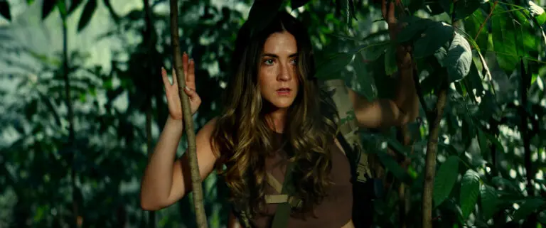 Isabelle Fuhrman in the jungle wearing camouflage.