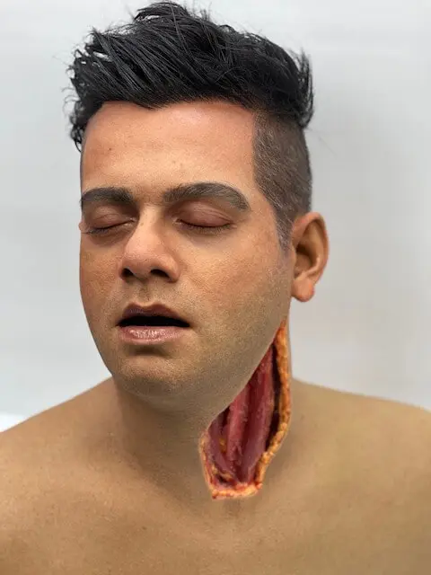 A special effects head  of a young man bearing neck wound.