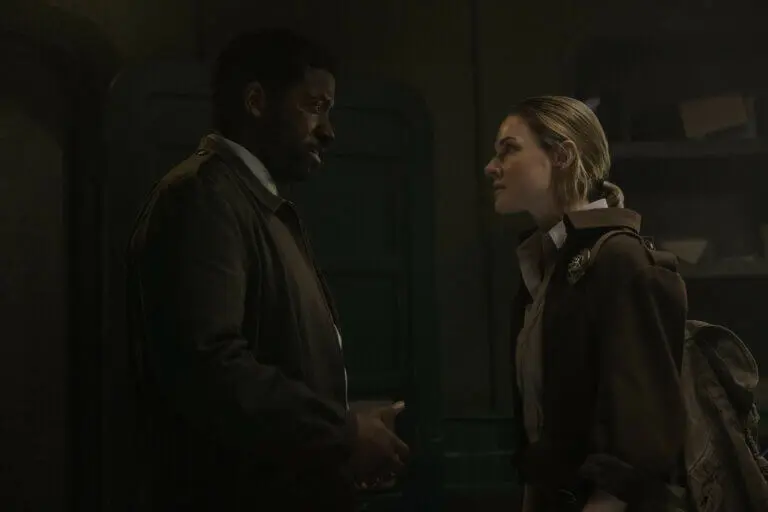 Chinaza Uche and Rebecca Ferguson talking in a small room.
