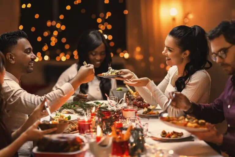 Diverse group of friends having dinner at a holiday party.