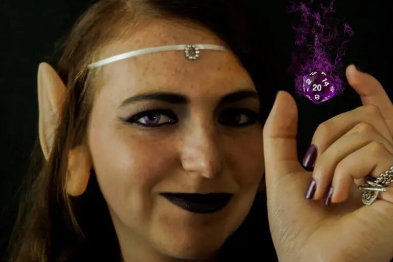 Female DnD player dressed as an elf using magic to levitate a D20 die.
