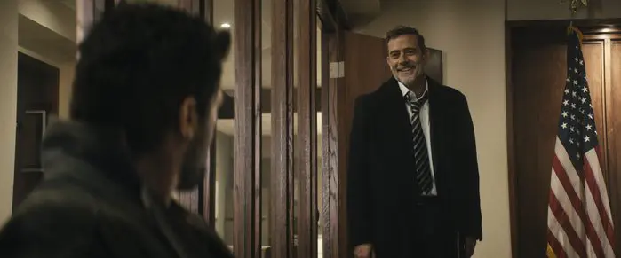 Jeffrey Dean Morgan smiling in a suit inside a government office as Joe Kessler on The Boys.