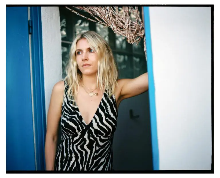 casting director Georgia Topley standing in the doorway of her home.