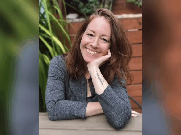 Casting Director Jessica Munks smiling outside in a grey sweater.
