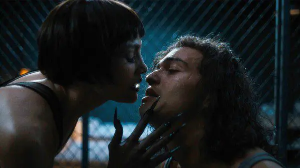 Jennifer Lopez with clawed hands embraces Tonatiuh in Kiss of the Spider Woman.