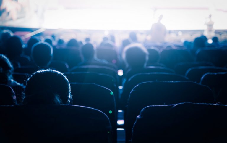 Audiences watching one of the many movie screening and premiers on our list this month.