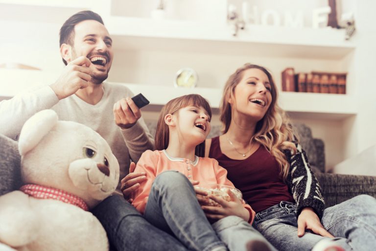 A family enjoying shows from this list of January television premiers.