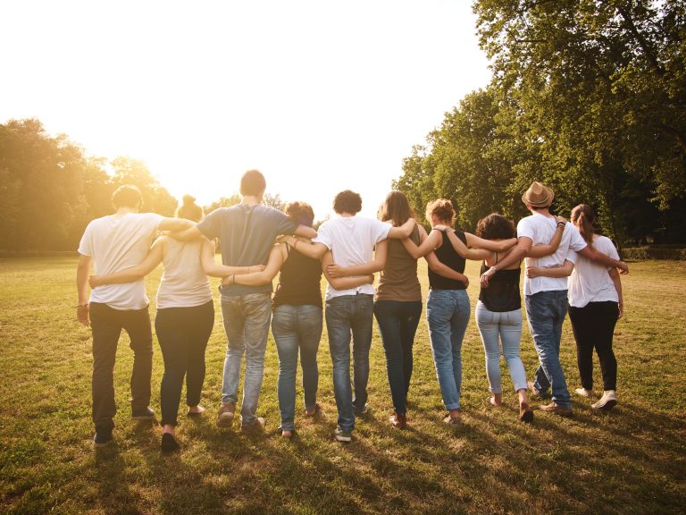 large group of friends together in a park having fun