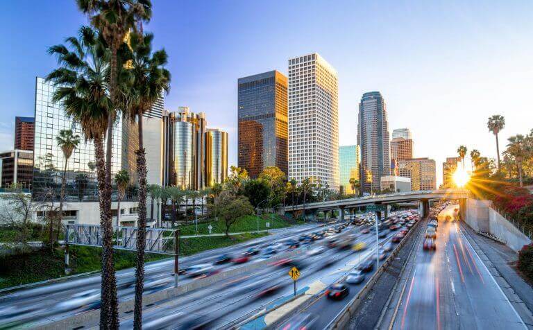 Los Angeles evening sunset highway traffic skyline buildings