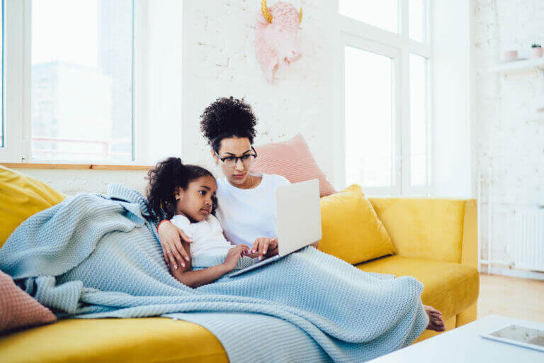 A mother watching one of the 3 best picture nominees on our list with her kid.