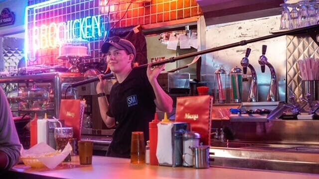 A Boom operator on a restaurant set explaining what their day entails.