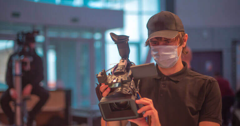 A member of a production team learning about what to expect during filming in a pandemic.