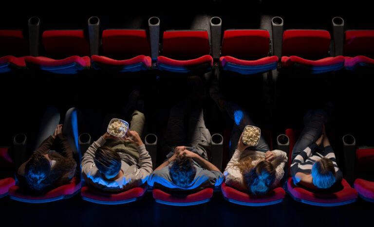 A group of actors at a movie theater watching movies that changed our liives.