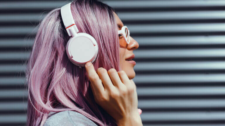 Woman listening to audio through headphones.