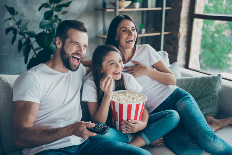 An actor couple and their child watching a movie streaming this month in our list.