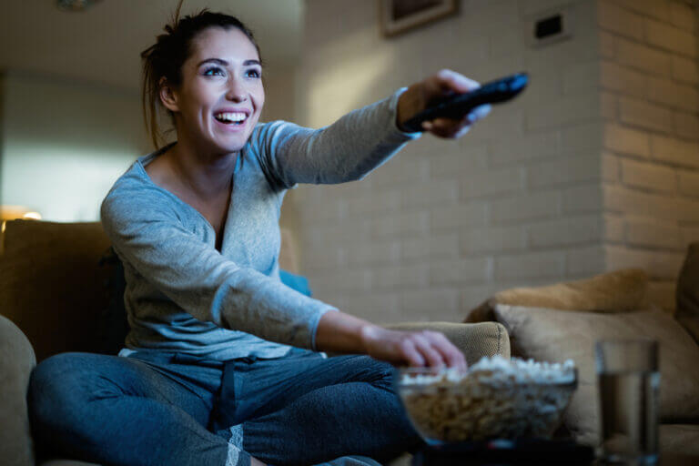 An actress sitting down and enjoying several of the new shows coming to streaming this month that she could not wait to see.