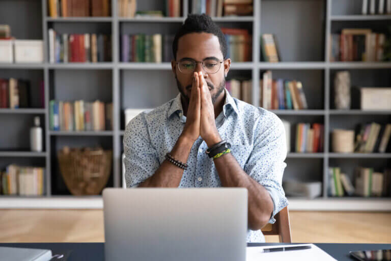 An African American actor battling imposter syndrome in his home office