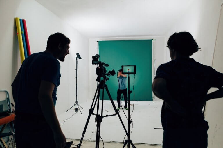 Two project creators preparing their self tape setups for actors to come in and record.