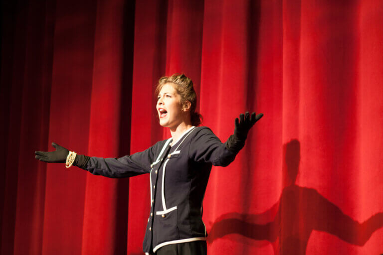 A woman acting on stage, dispelling an acting myth she heard.