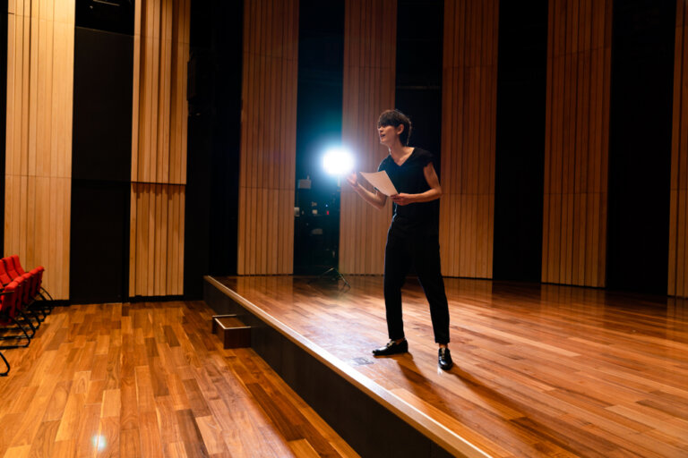 An actor taking direction during an audition. Here he is on stage and in front of the casting director giving it his all.