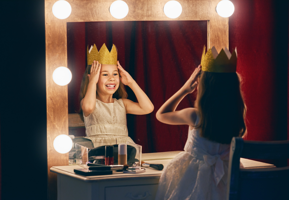 A child actress getting ready to go onstage.