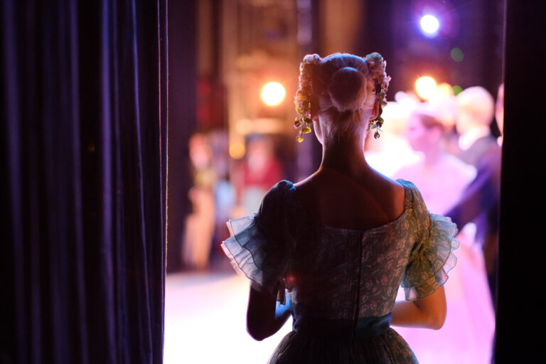 An actress on an education tour getting ready to go onstage for the first of several shows.