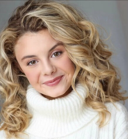 Actress Mallory James Mahoney in a white turtleneck.