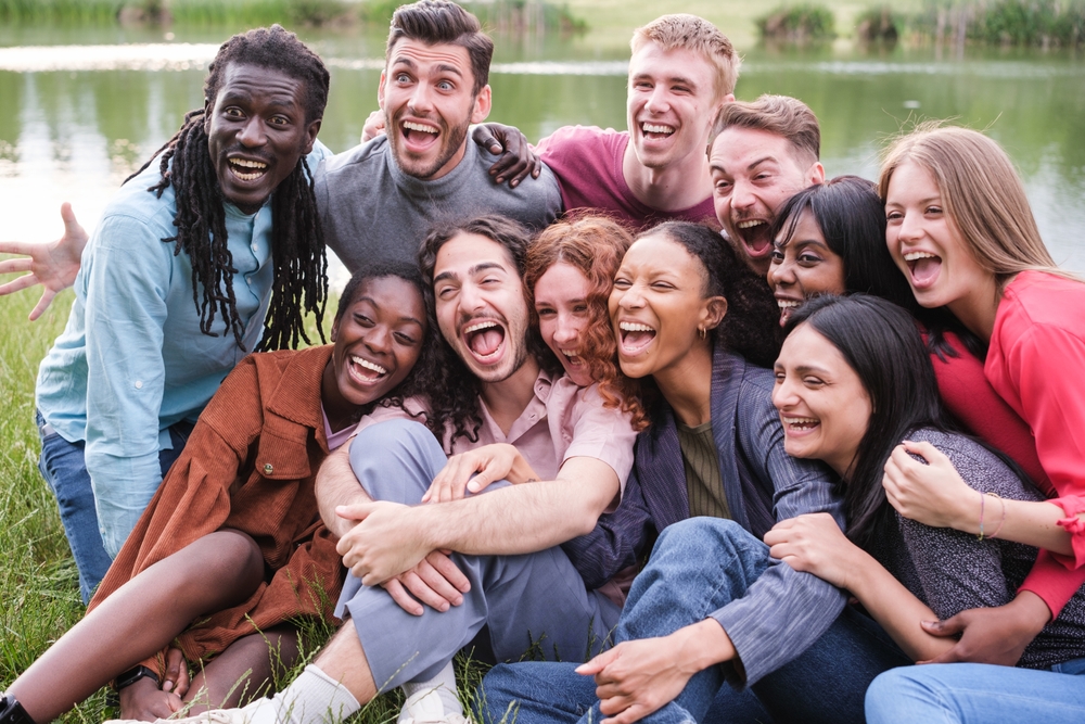 A group of diverse friends hanging out in a park.