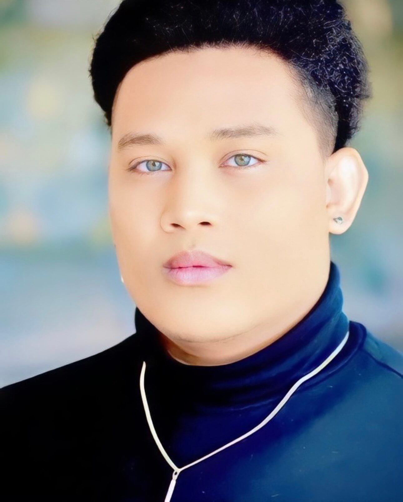 A headshot of Actor Marquis Stewart in a blue shirt.