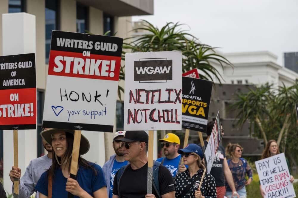 A picket line full of WGA writers striking outside.