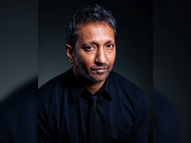 Actor Phaldut Sharma in a black shirt looking stoic.