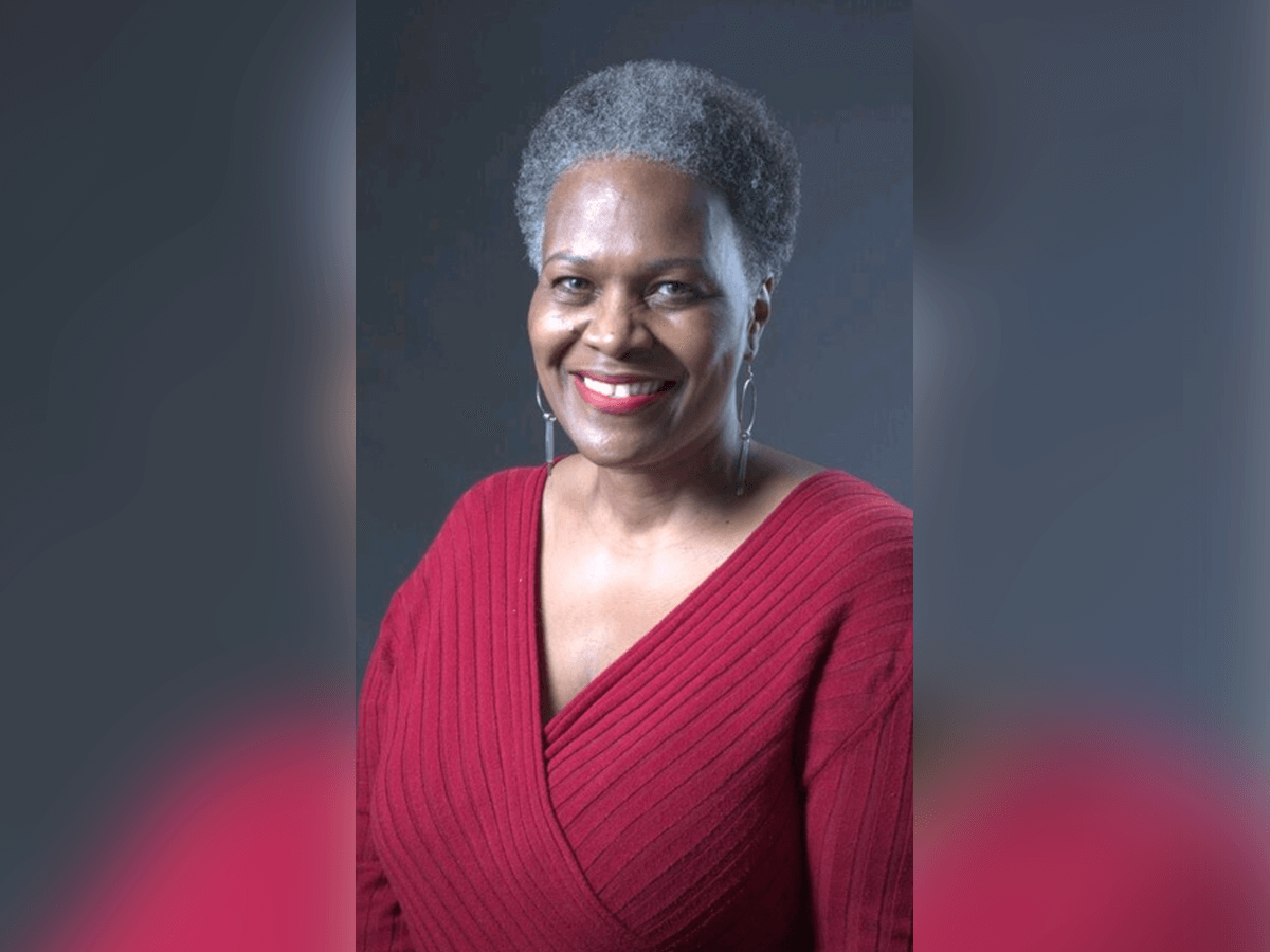 Headshot of actor Henrí A. Sallis in a red sweater.