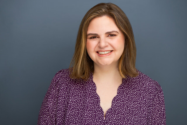 Casting director Jodi Angstreich in a purple shirt smiling.