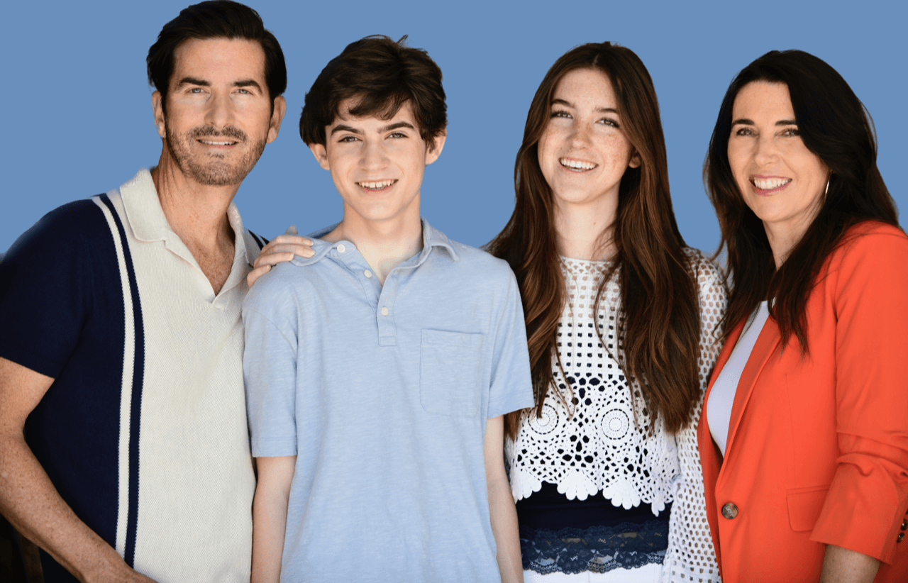 A family of actors known as the Lawrence Family posing together and smiling.