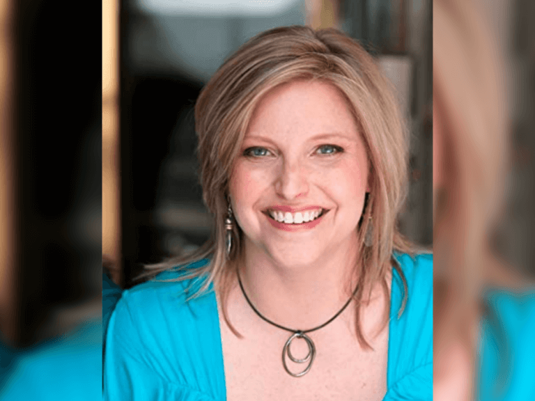 Casting Director Jennifer Rudnicke smiling in a blue shirt.