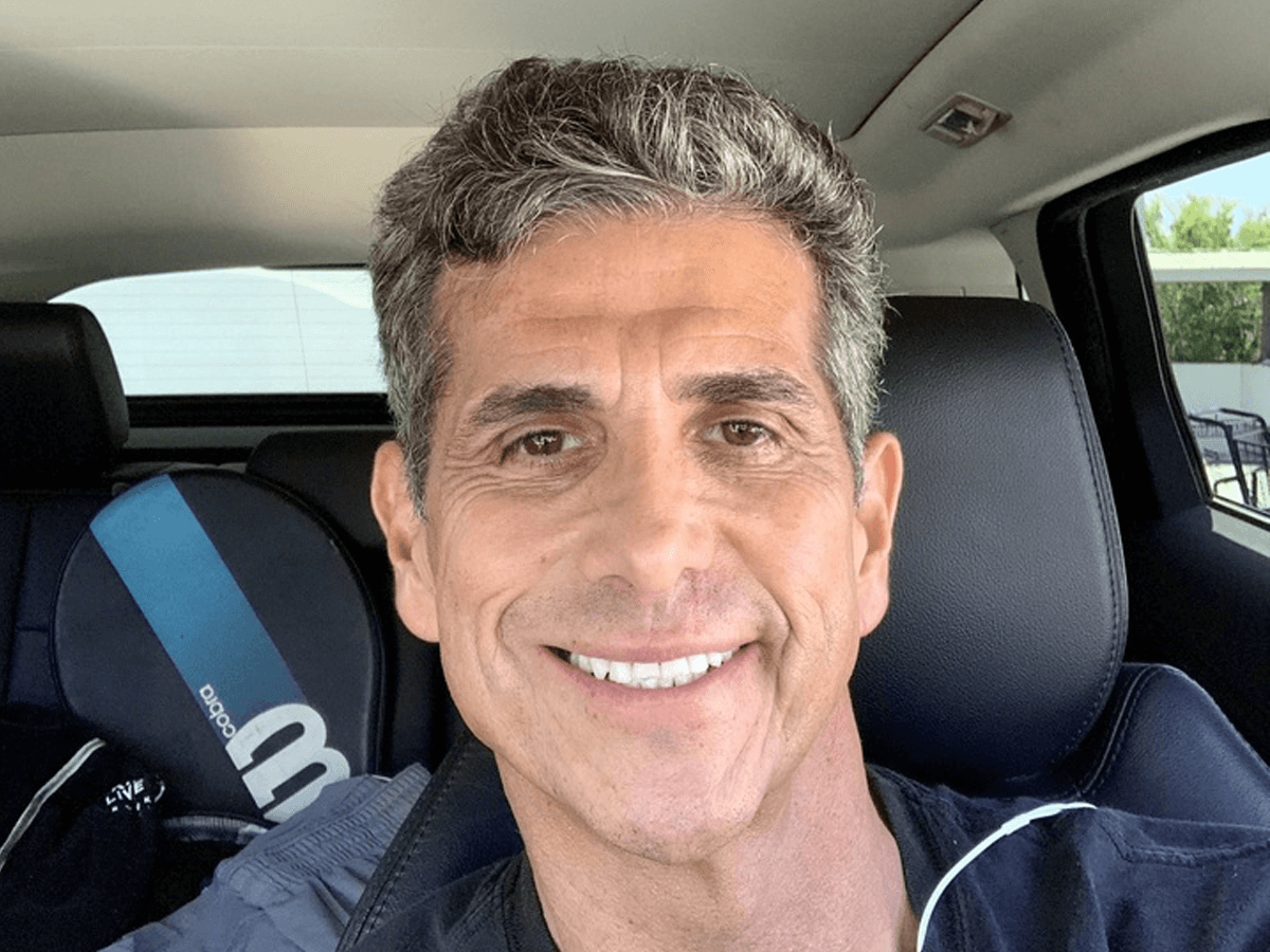 Actor Dereck Andrade smiling in his car.