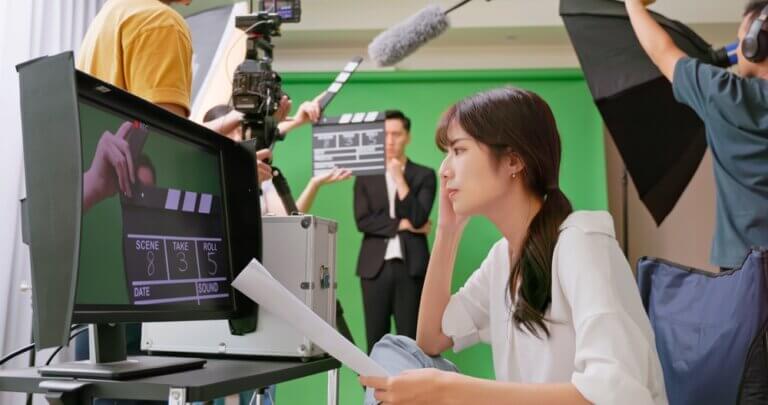 Asian movie director and crew auditioning an actor for a role.