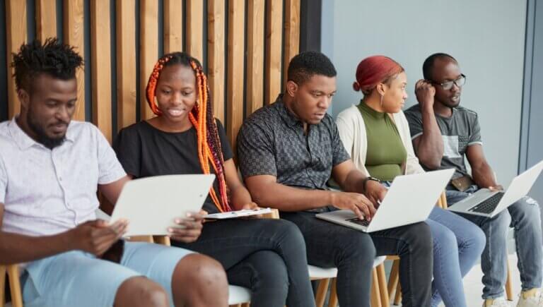 A group of diverse actors waiting in the audition room.
