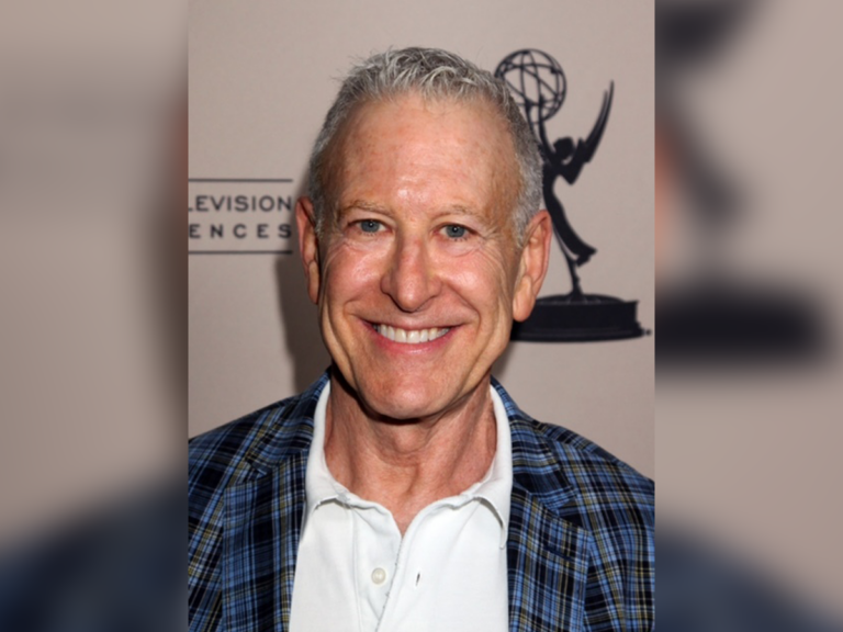 Casting director Jeff Greenberg in a plaid suit smiling.