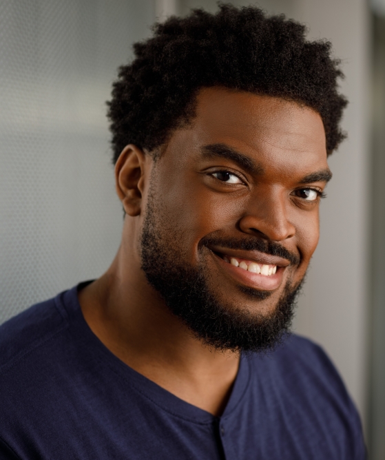 Actor Mark Willis smiling in a blue shirt.