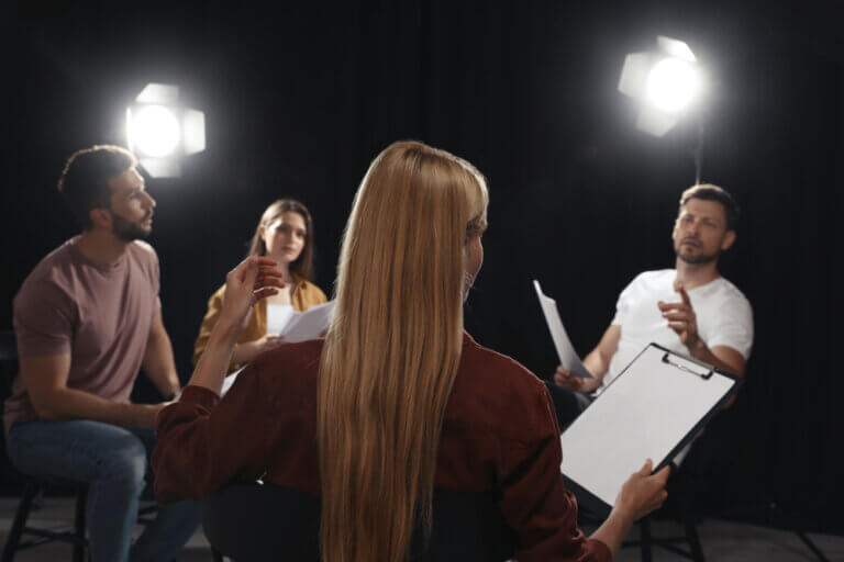 Actors reading through their lines getting called by the casting associate to audition.