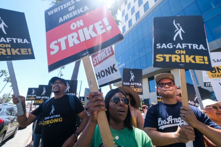 WGA writers and SAG-AFTRA actors striking together outside.