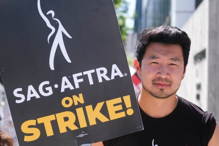 Picket sign in hand, actor Simu Liu joing the SAG-AFTRA writer's strike.