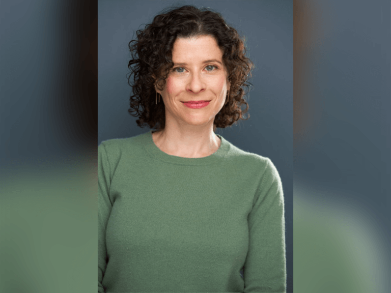 Casting director Kate Geller smiling in a green sweater.