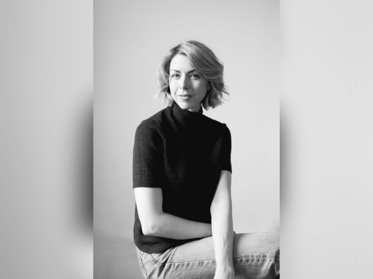 Black and white photo of Katherine Warnock posing and smiling.