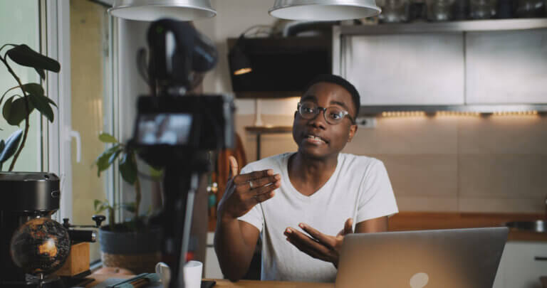An African American actor recording a self tape audition in his home.