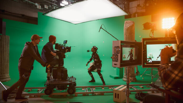 A film crew shooting a scene with a motion capture actor.