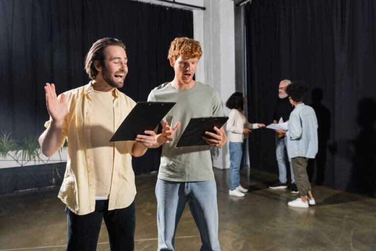 Actors reviewing their audition books.