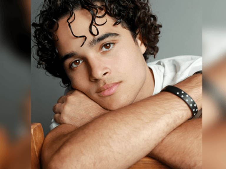 Actor Jalen Thomas Brooks sitting in a chair with his arms crossed.