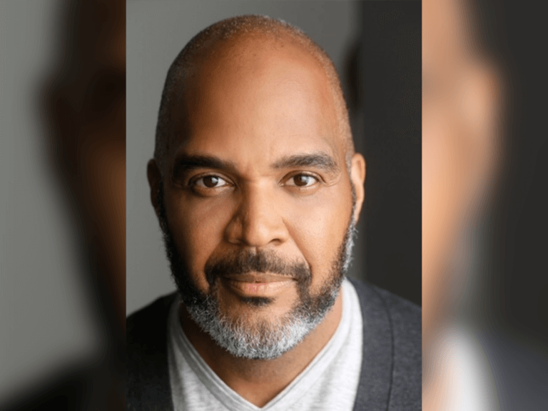 Victor Williams in a sweater smiling.
